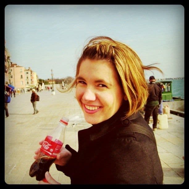 Woman with a drink on a boardwalk