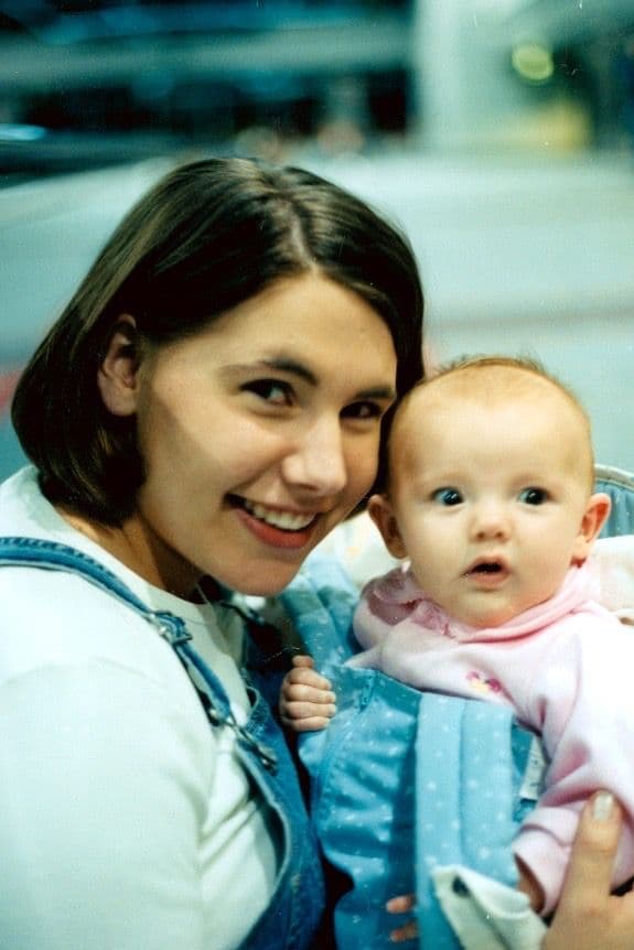 Woman holding a baby outdoors