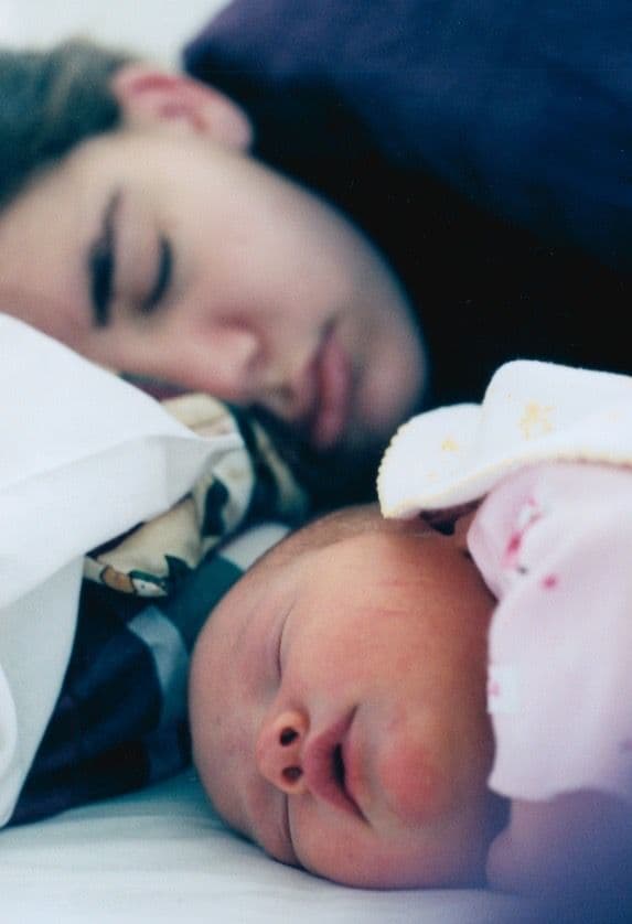 Close-up of woman holding a newborn