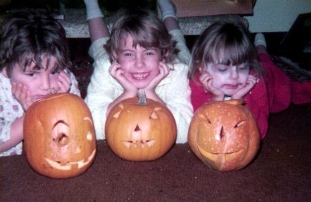 Three girls with carved pumpkins