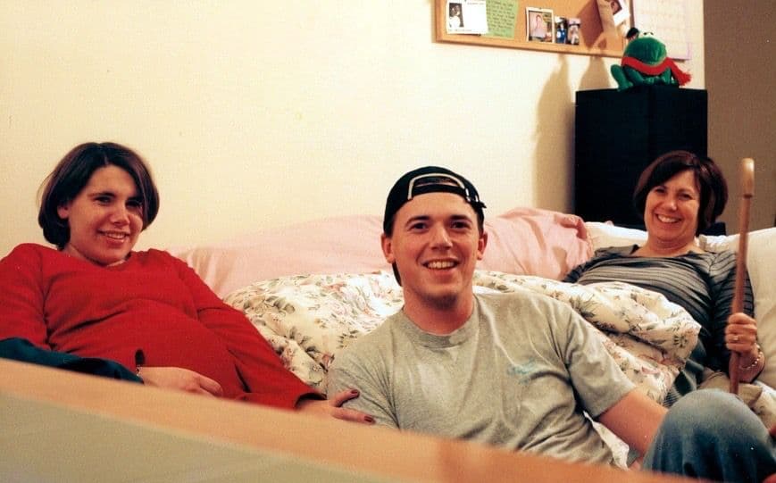 Young man and woman sitting together, older photo