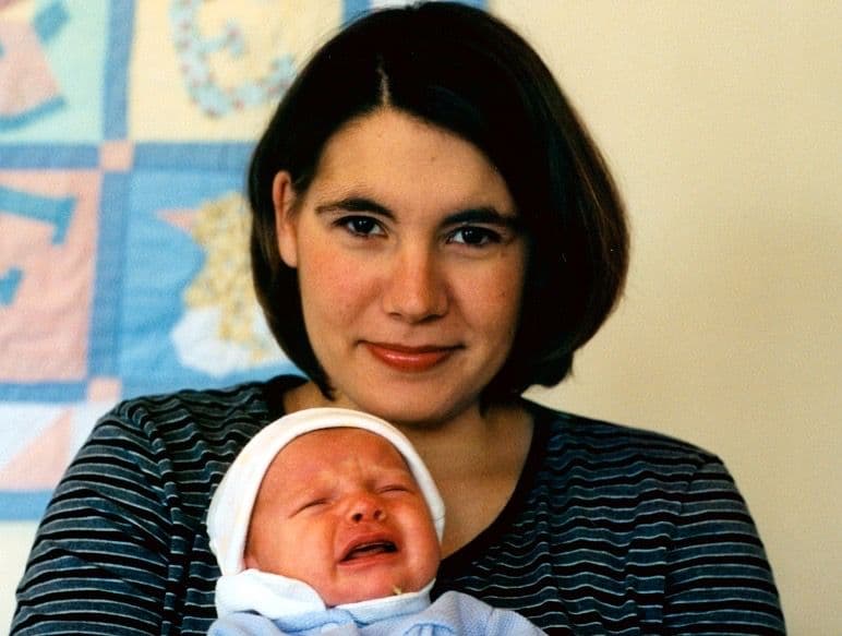 Woman holding a crying newborn