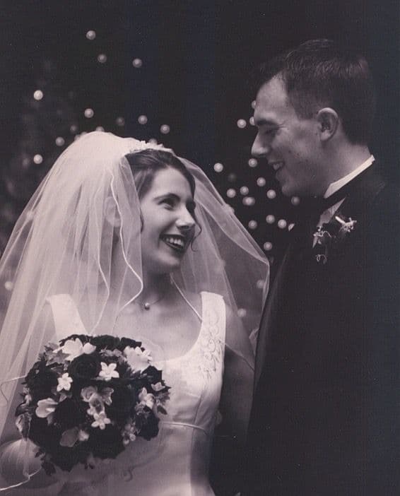 Bride and groom close together with bubbles