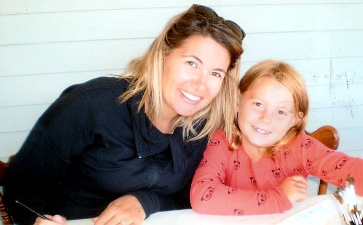 Woman and girl smiling at table