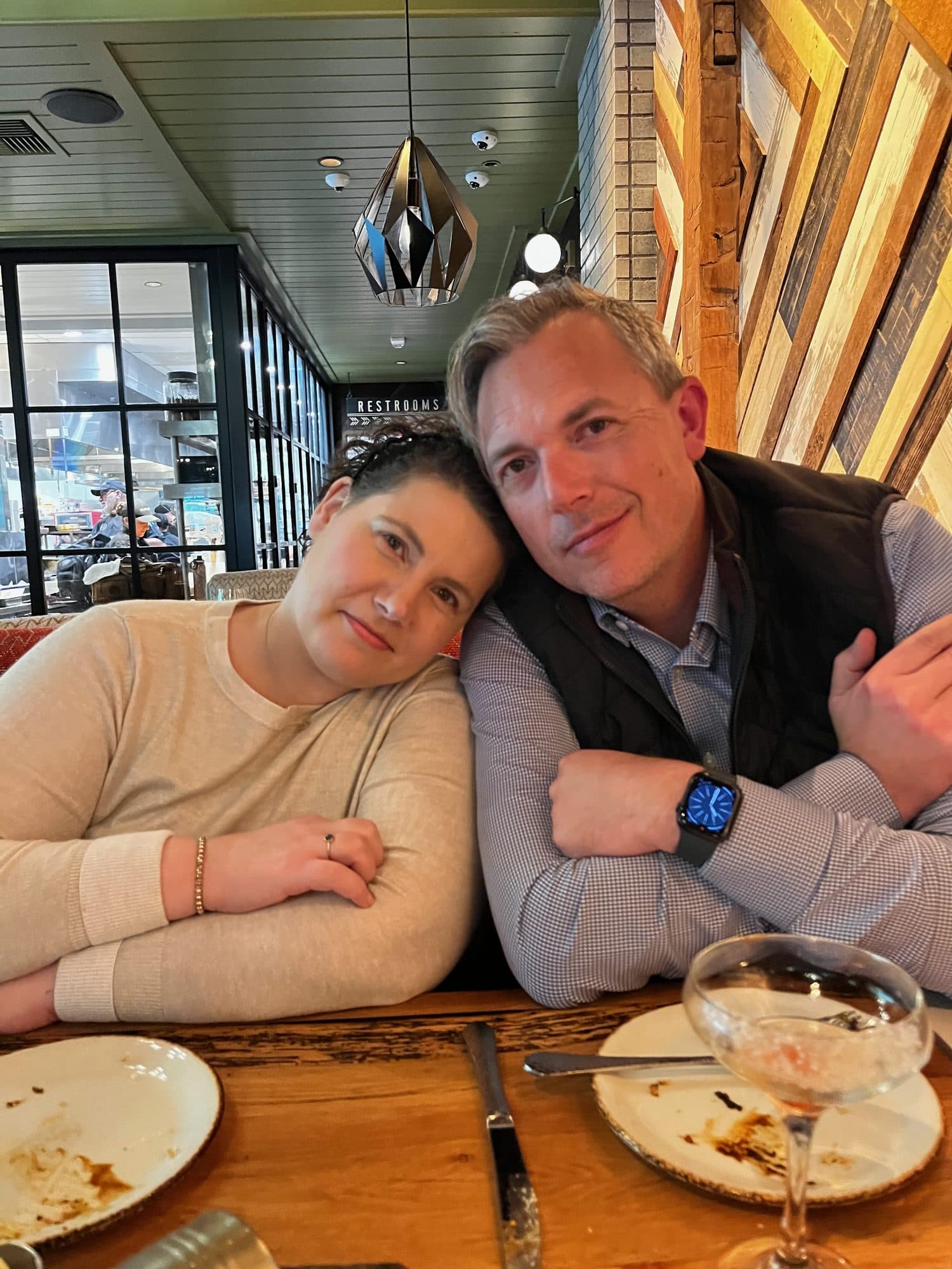 Woman and man leaning together at dinner