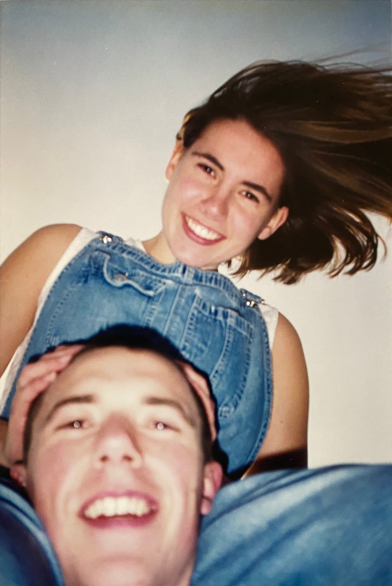 Playful photo of woman with man below