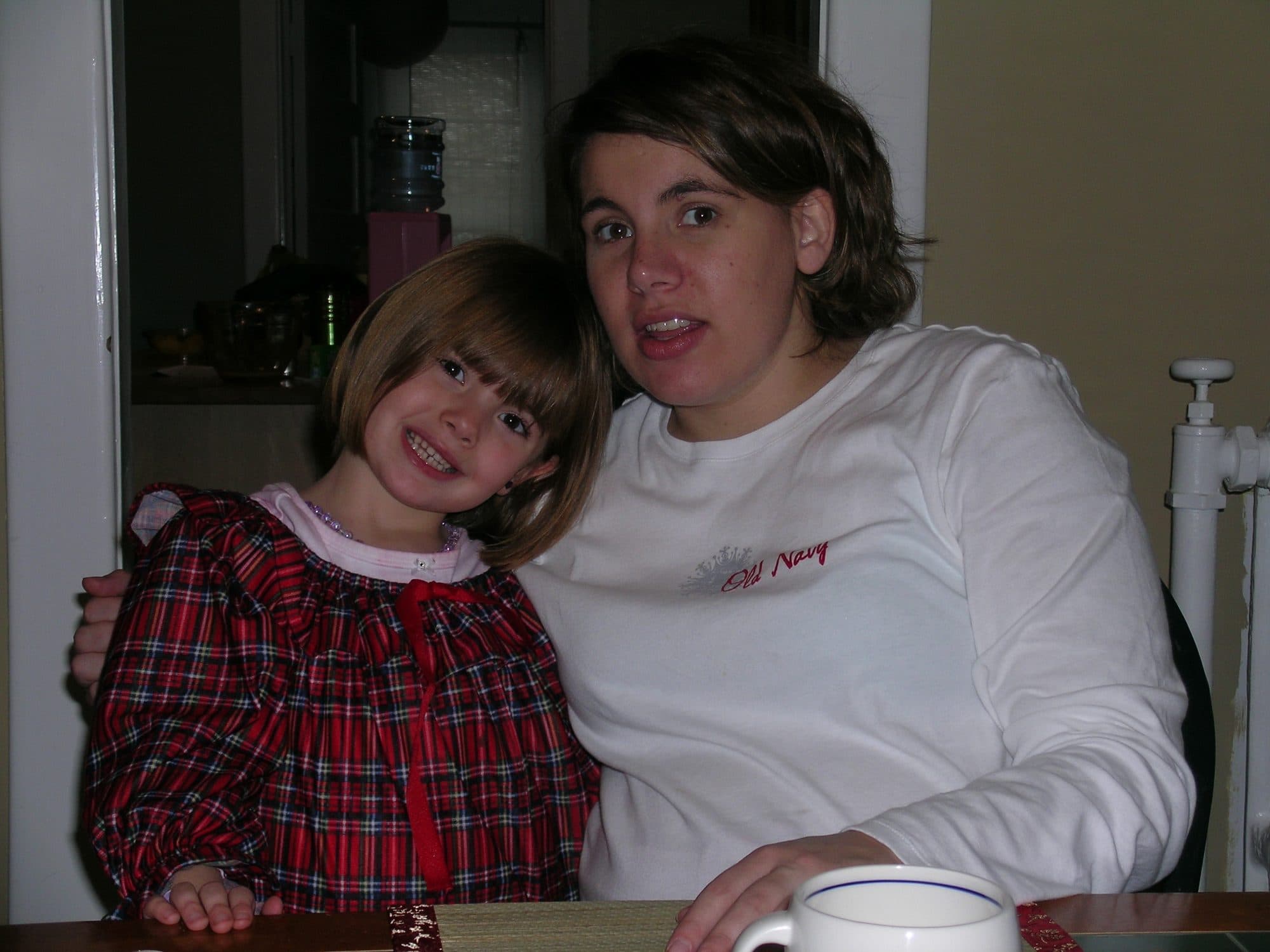 Girl and woman pose together indoors