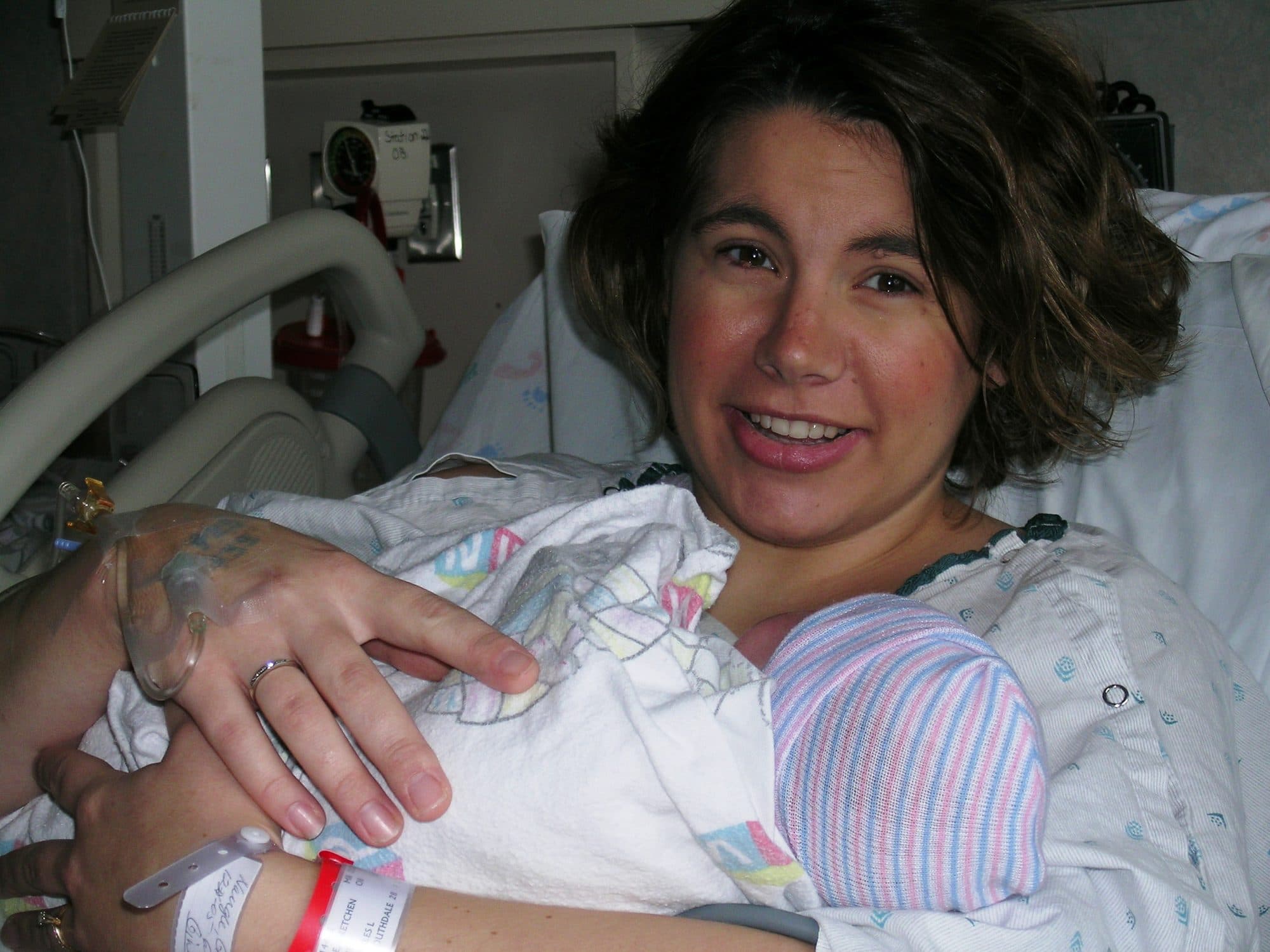 Smiling mother holds her newborn