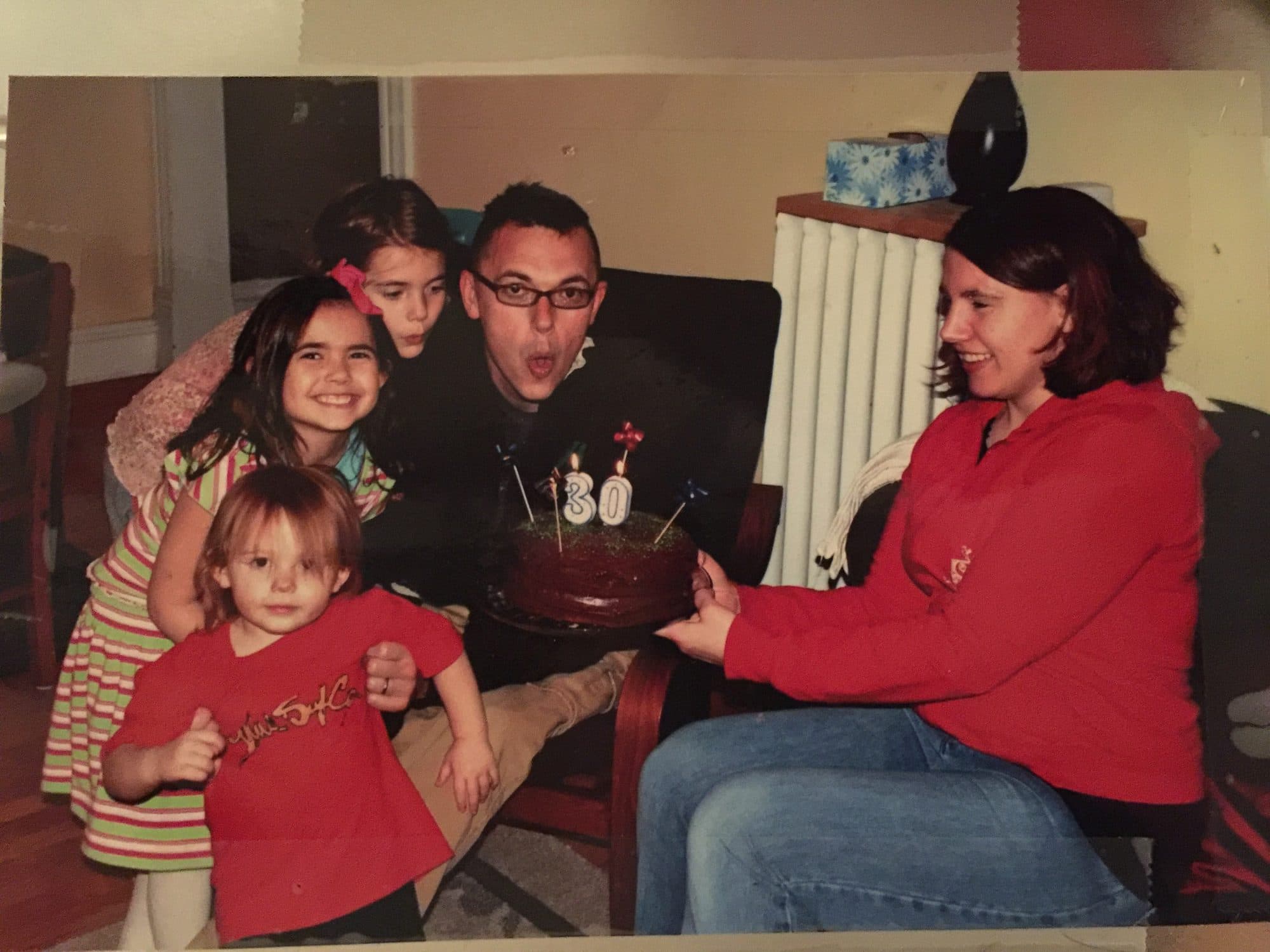 Family celebrates a 30th birthday with cake