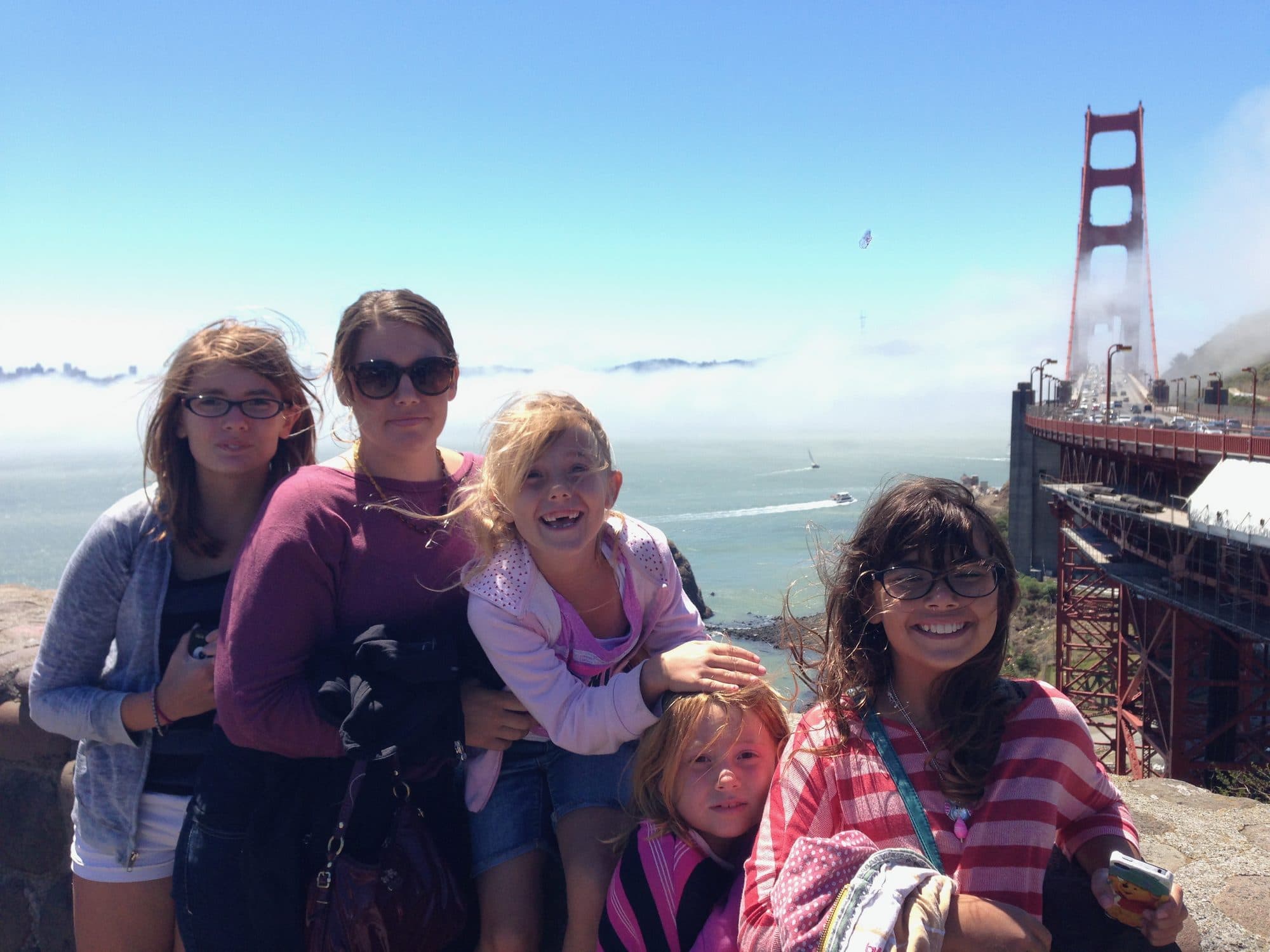 Family poses near the Golden Gate Bridge