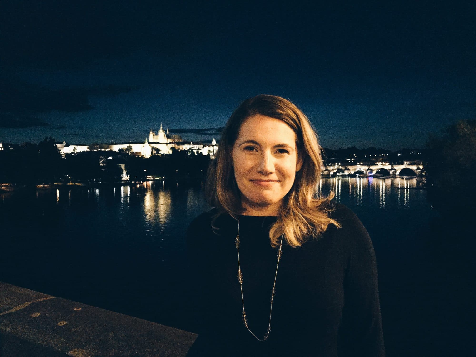 Portrait of a woman lit by a night skyline