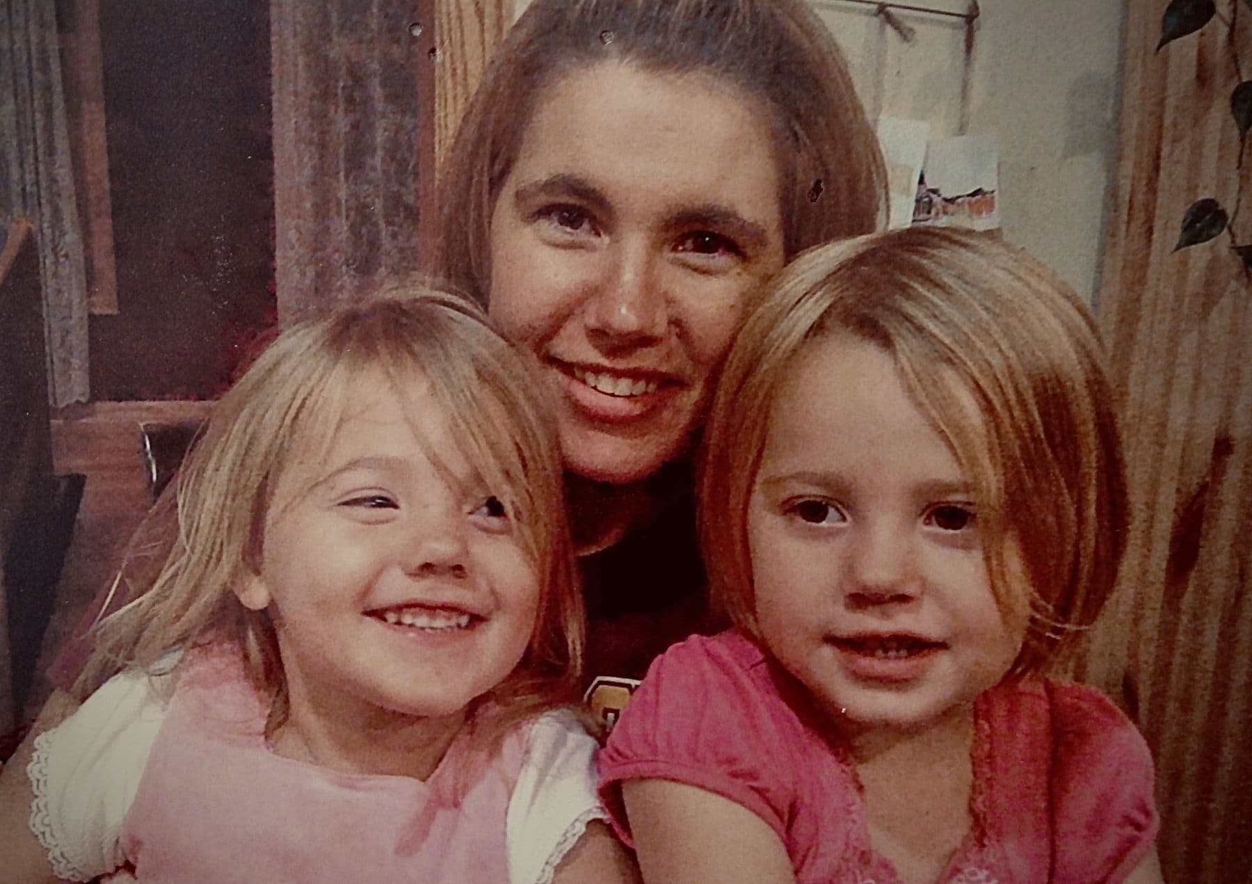 Woman poses with two young girls