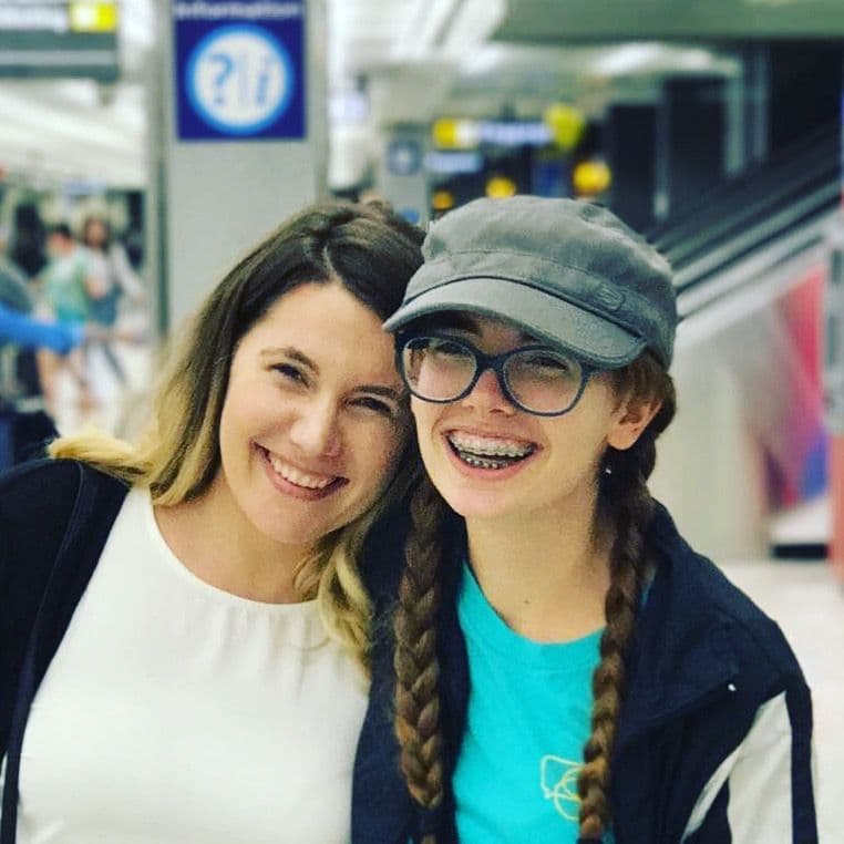Two women smiling together indoors