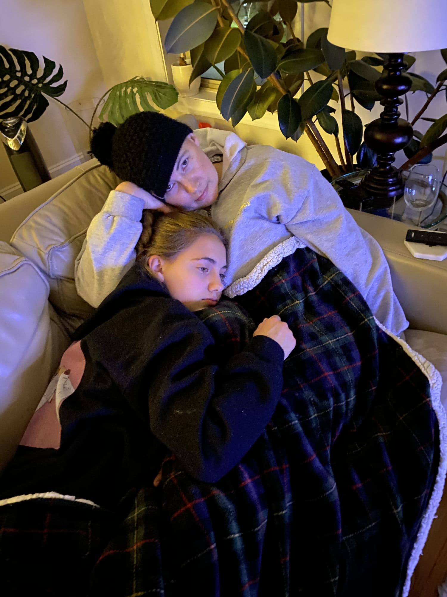 Two people cuddling under a blanket