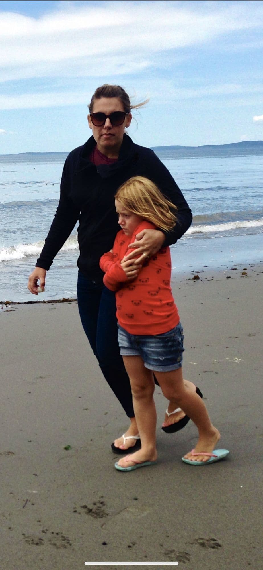 Man carrying a girl on the beach