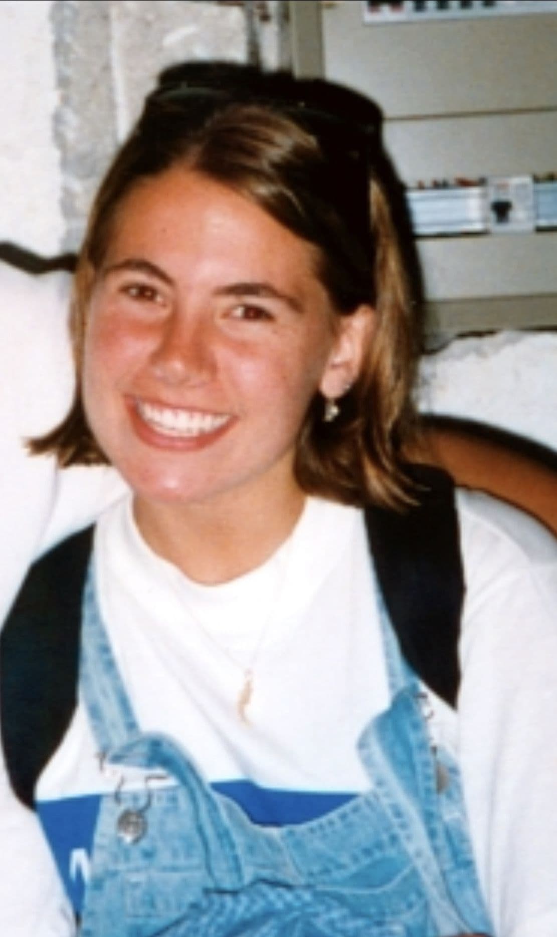 Teen girl in overalls with a backpack