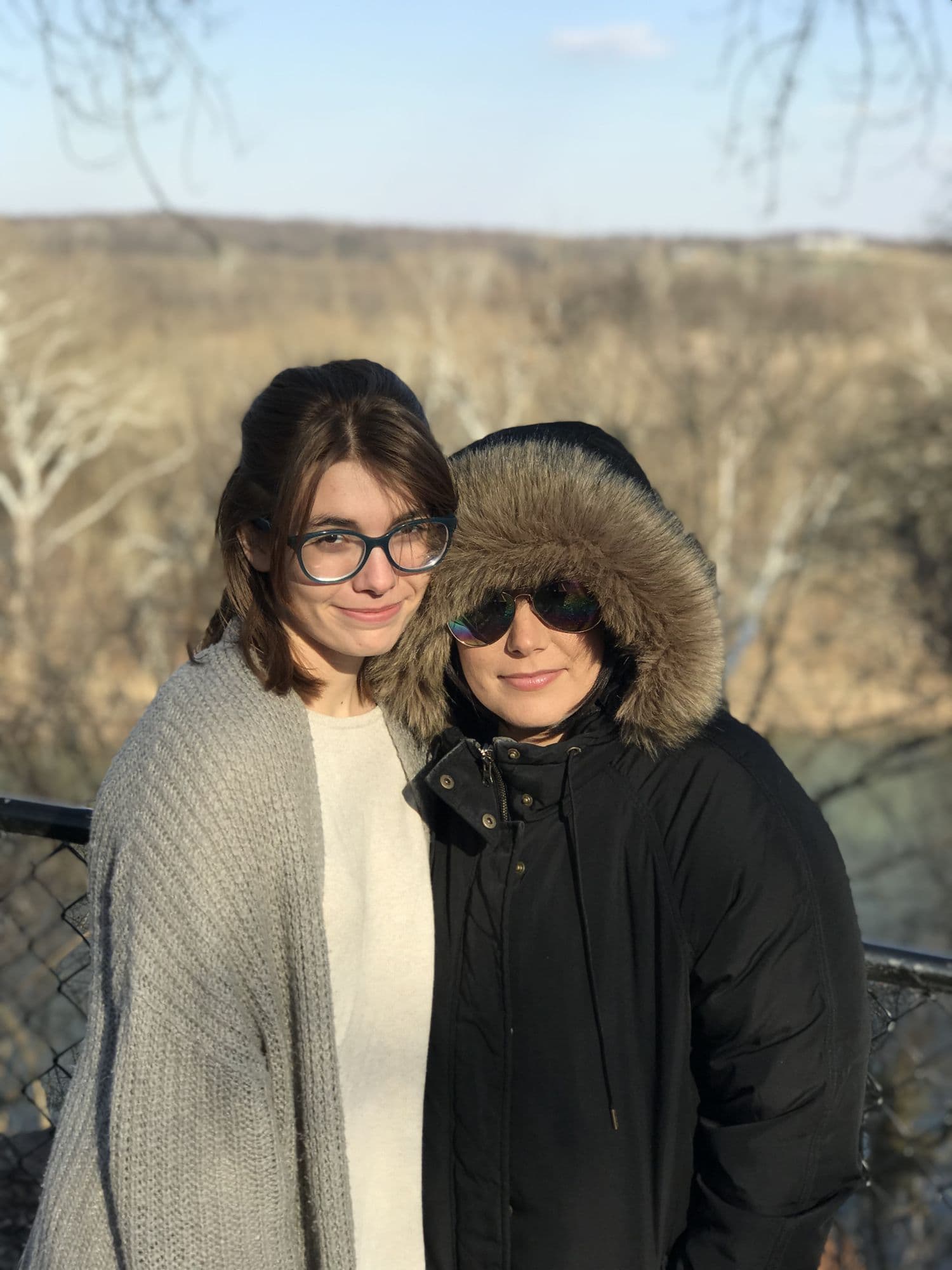 Two women embracing outdoors in winter
