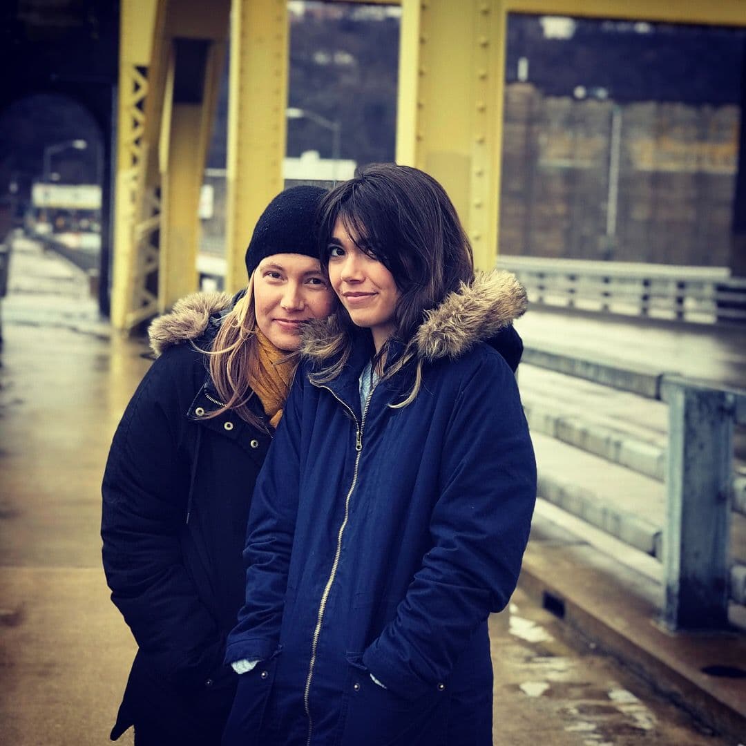 Two women on a bridge walkway