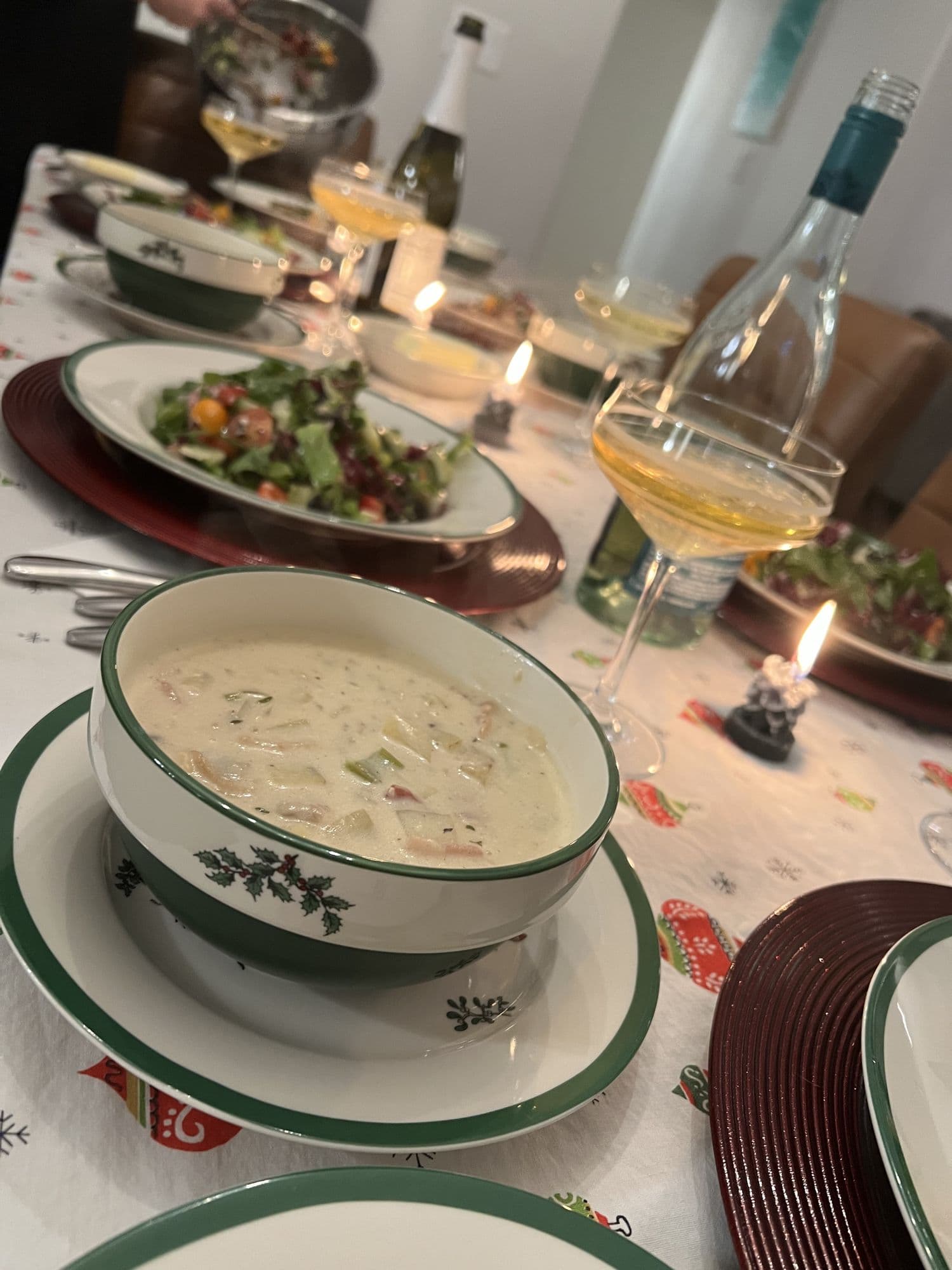 Holiday table set with soup and wine