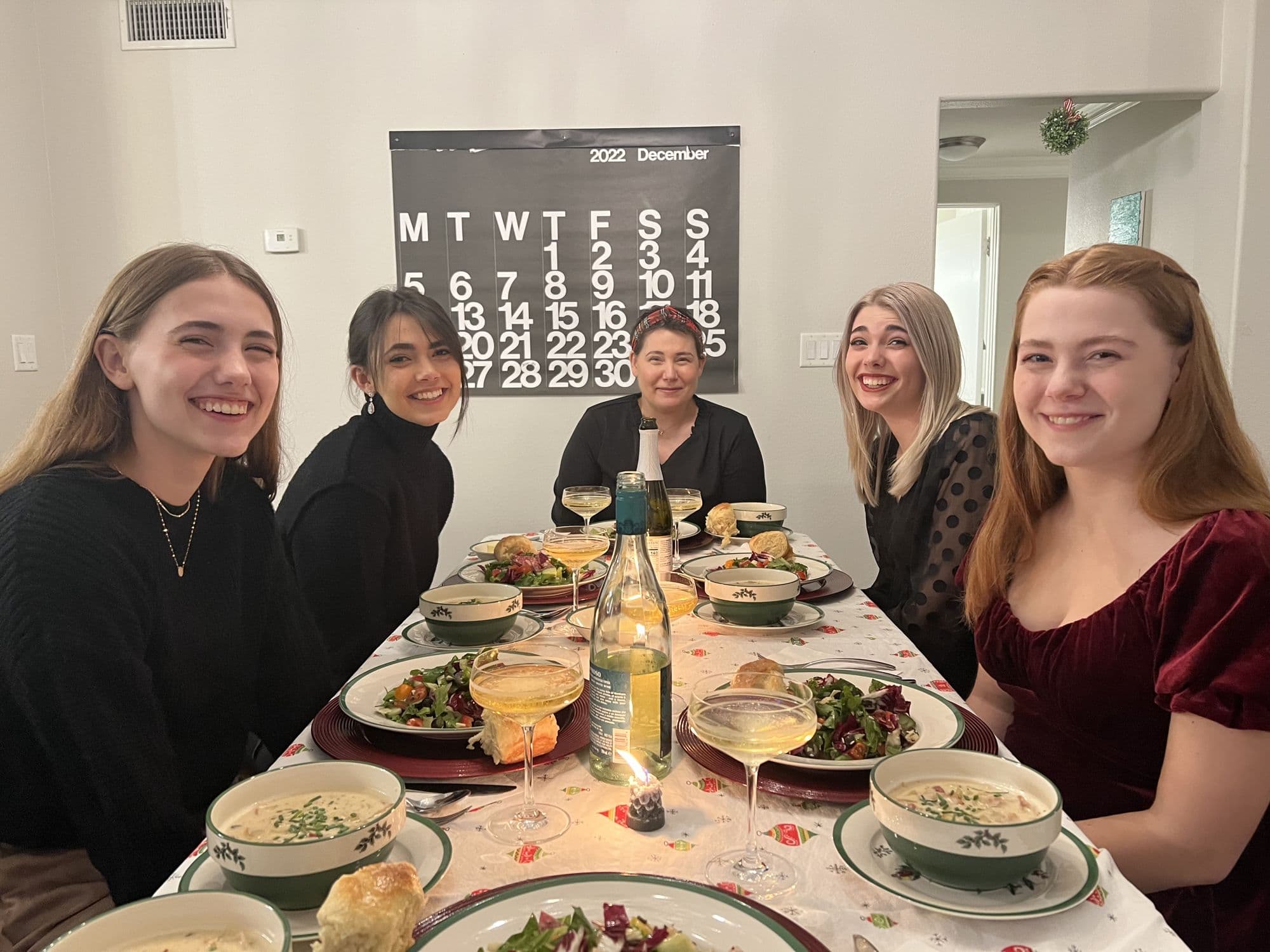 Five people at a holiday dinner table