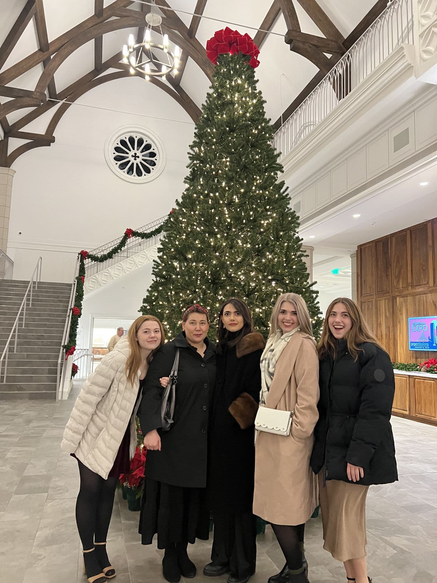 Group photo beside a Christmas tree