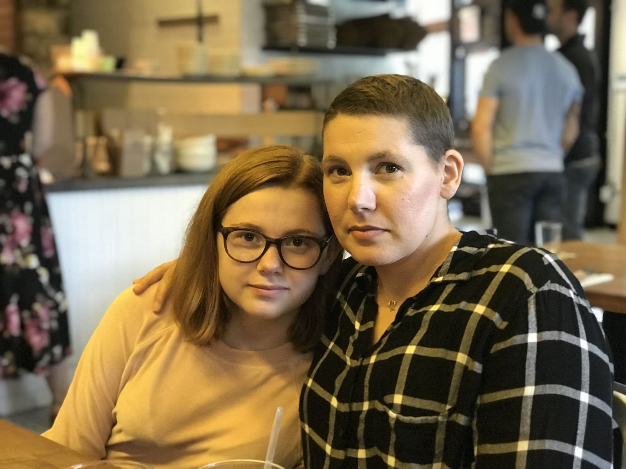 Woman and teenage girl at a cafe table