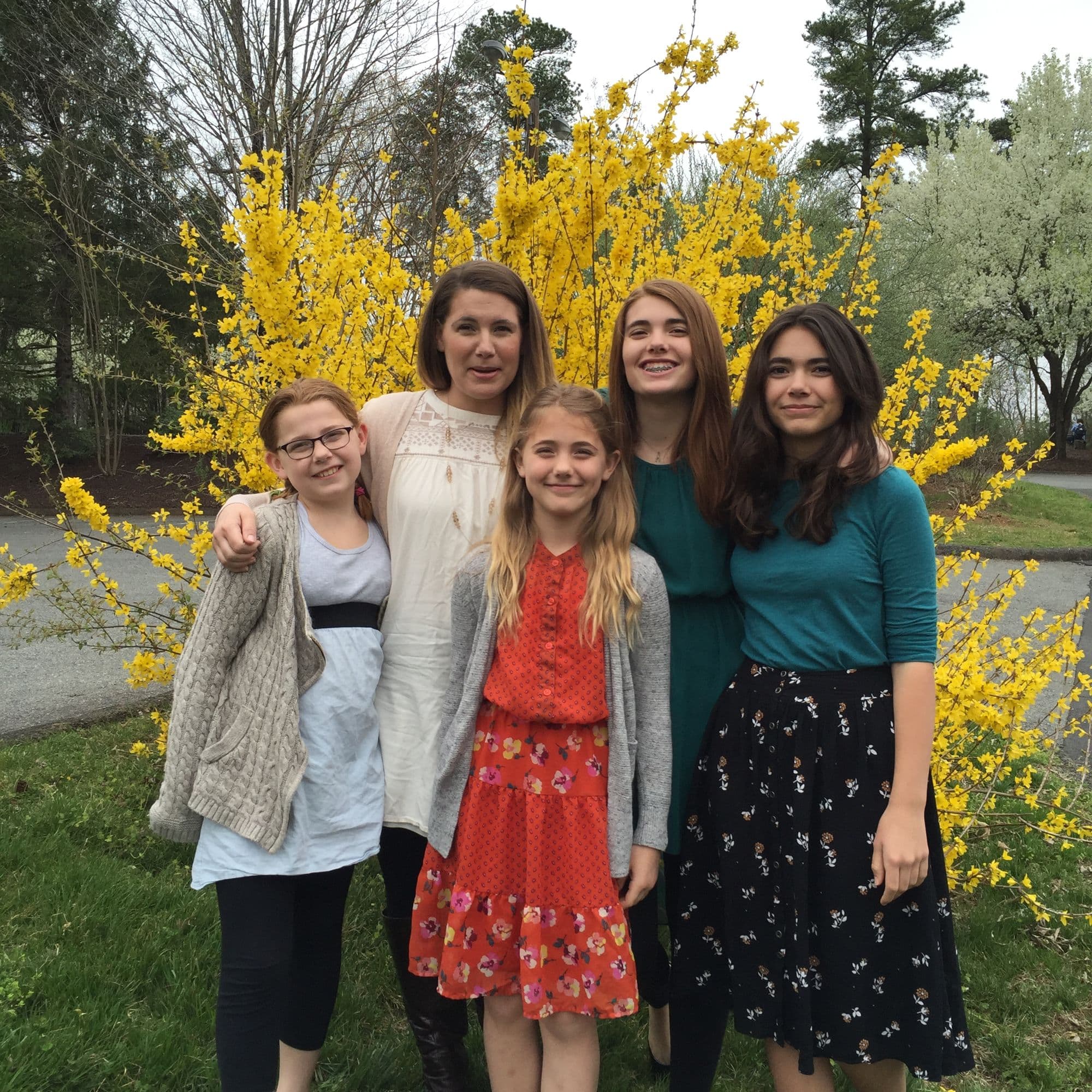 Group of girls posed by flowers