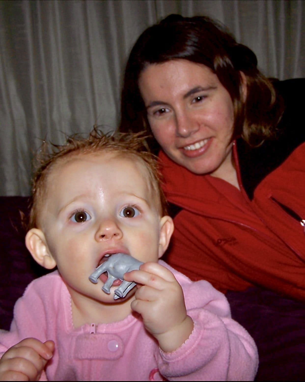 Woman holding baby with pacifier