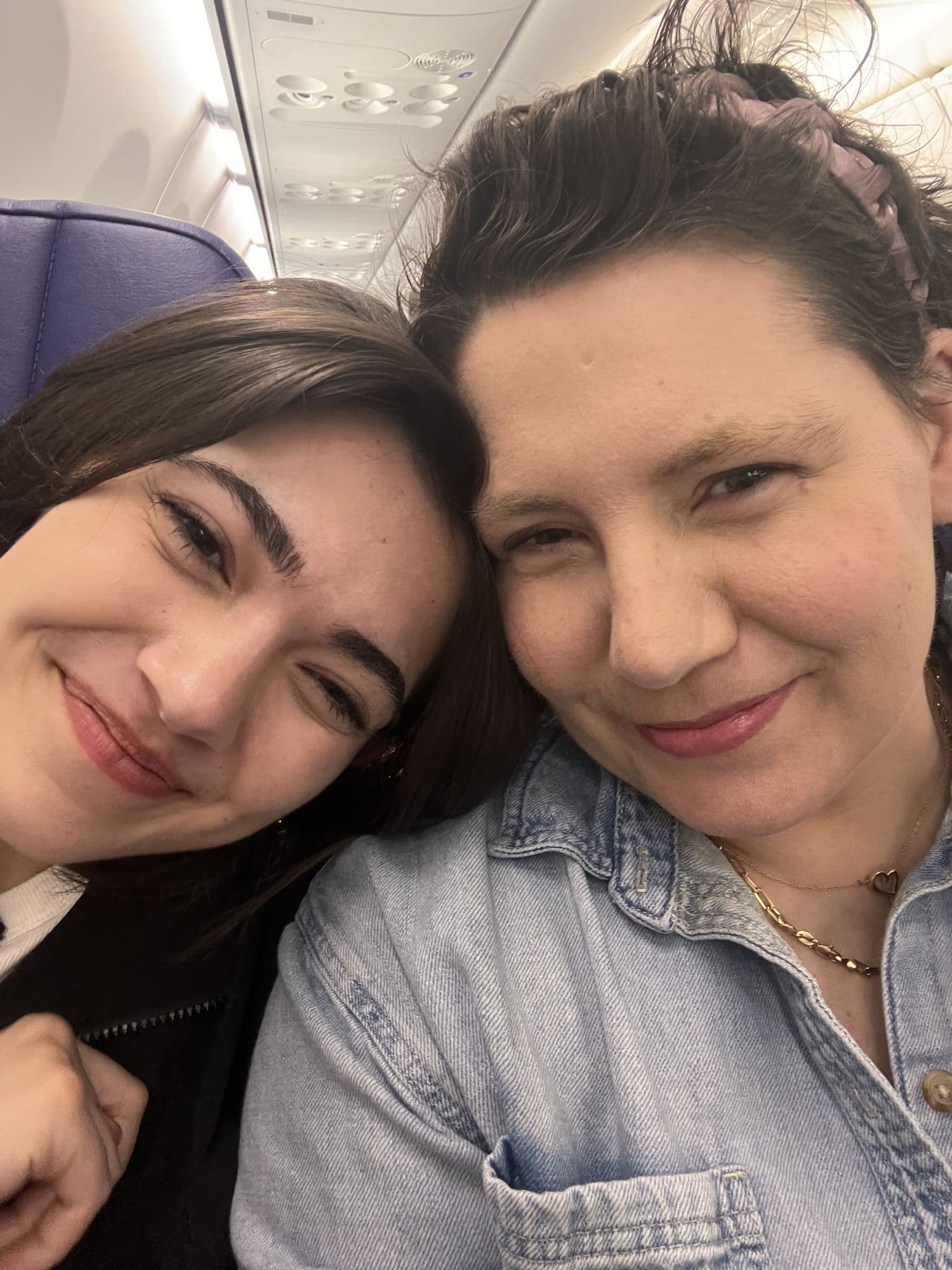 Two women in a close selfie indoors