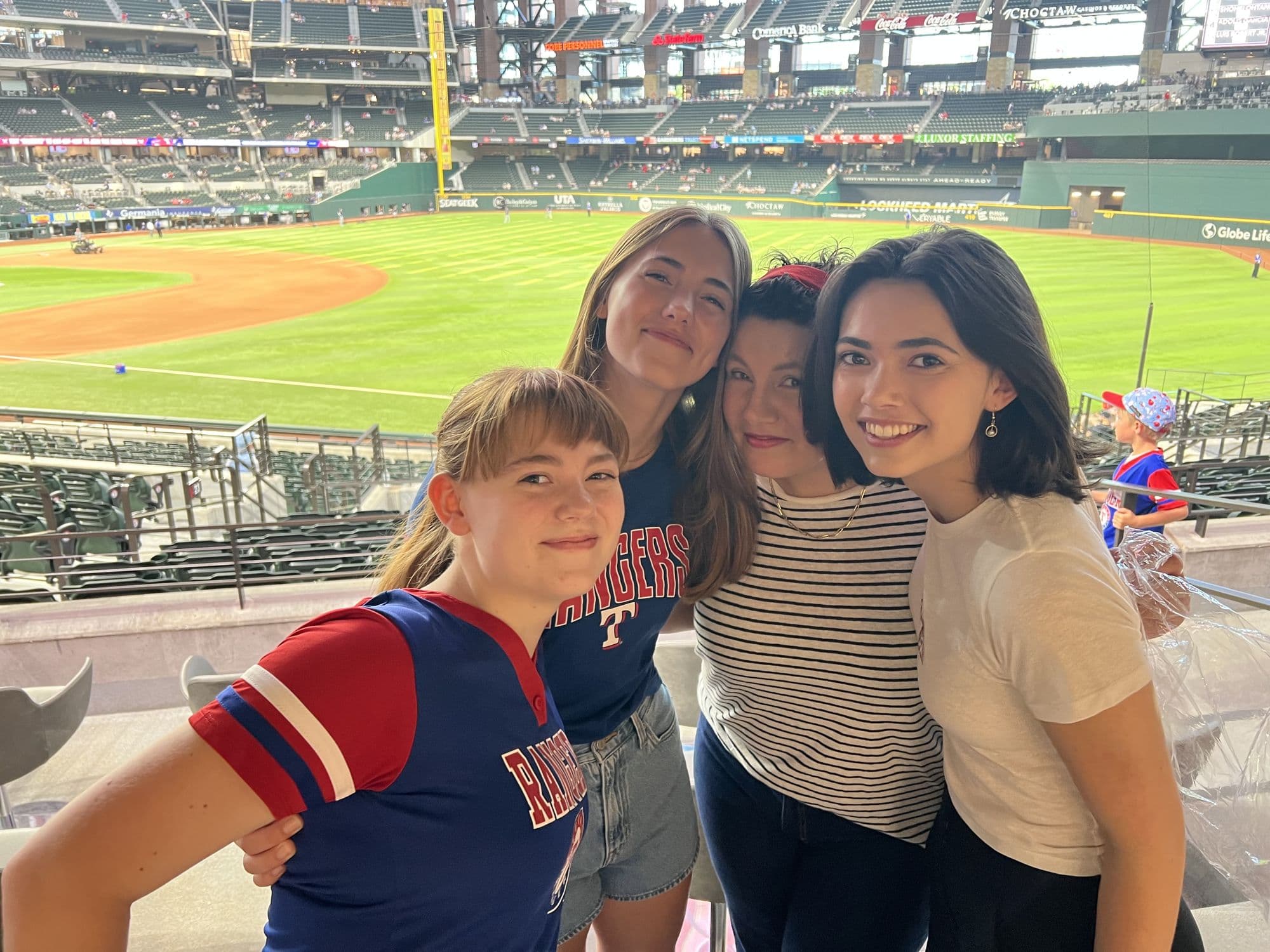 Four people at a baseball stadium