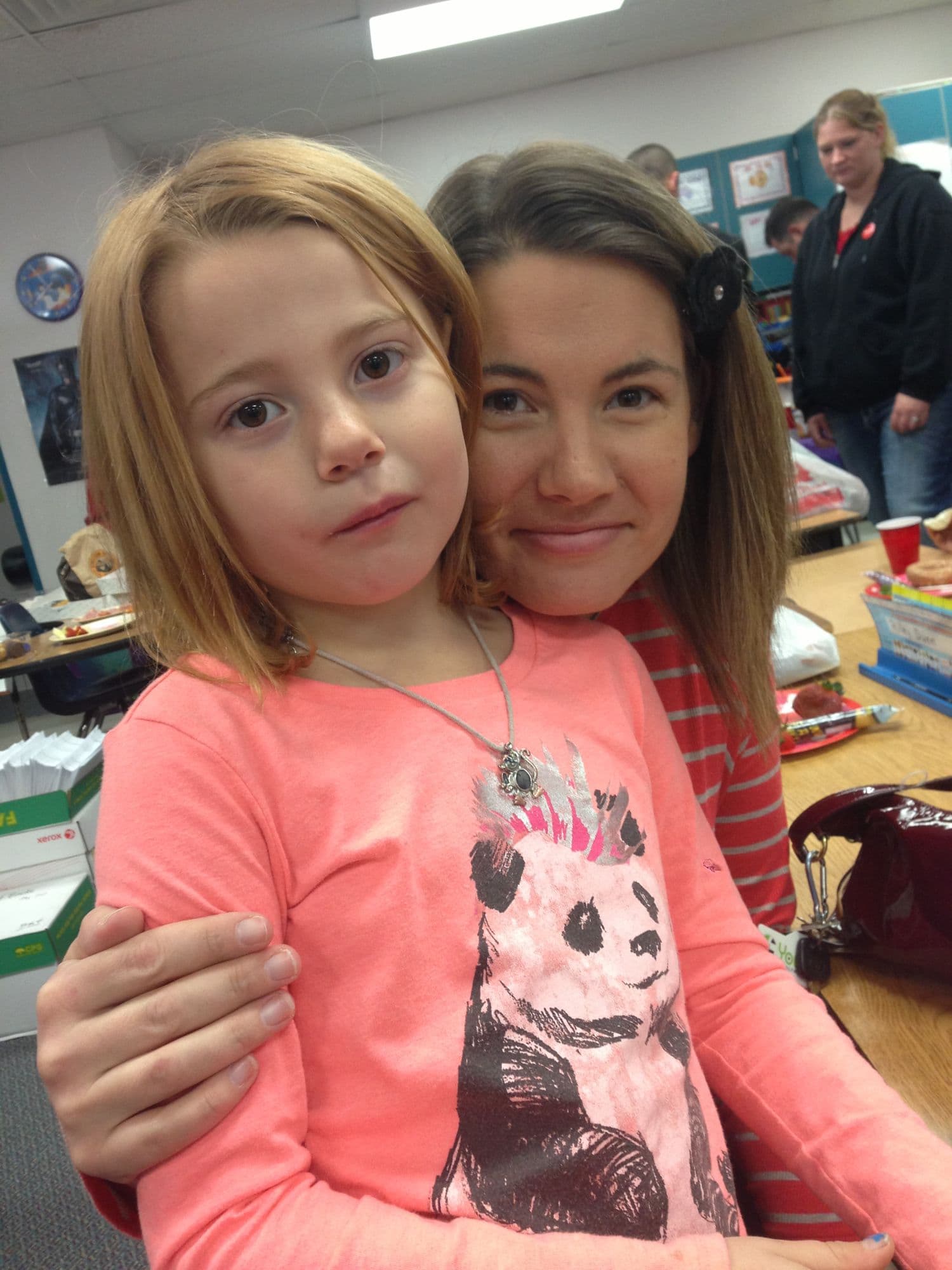 Two girls close together, one in a panda shirt