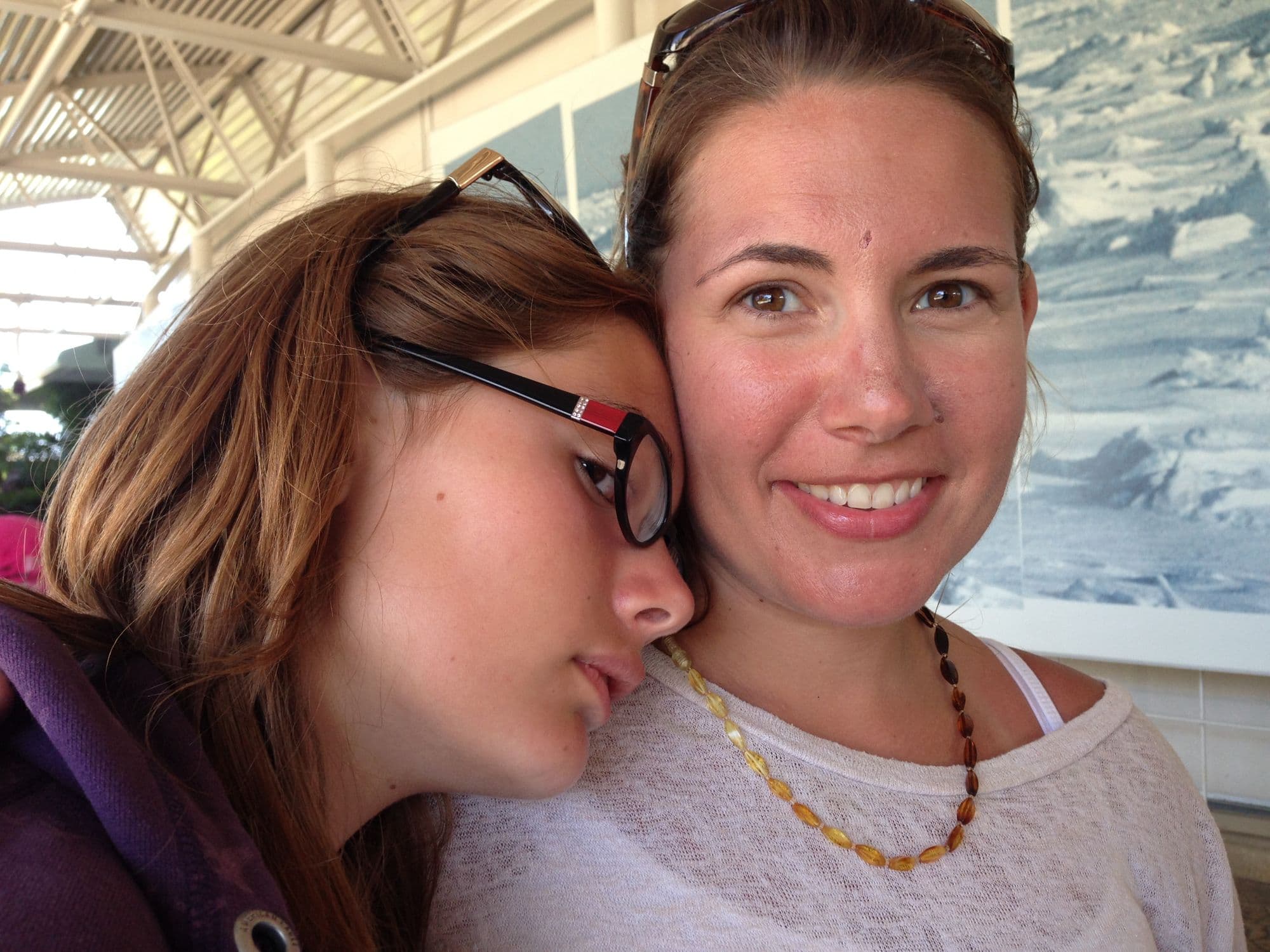Woman and teen pose cheek to cheek