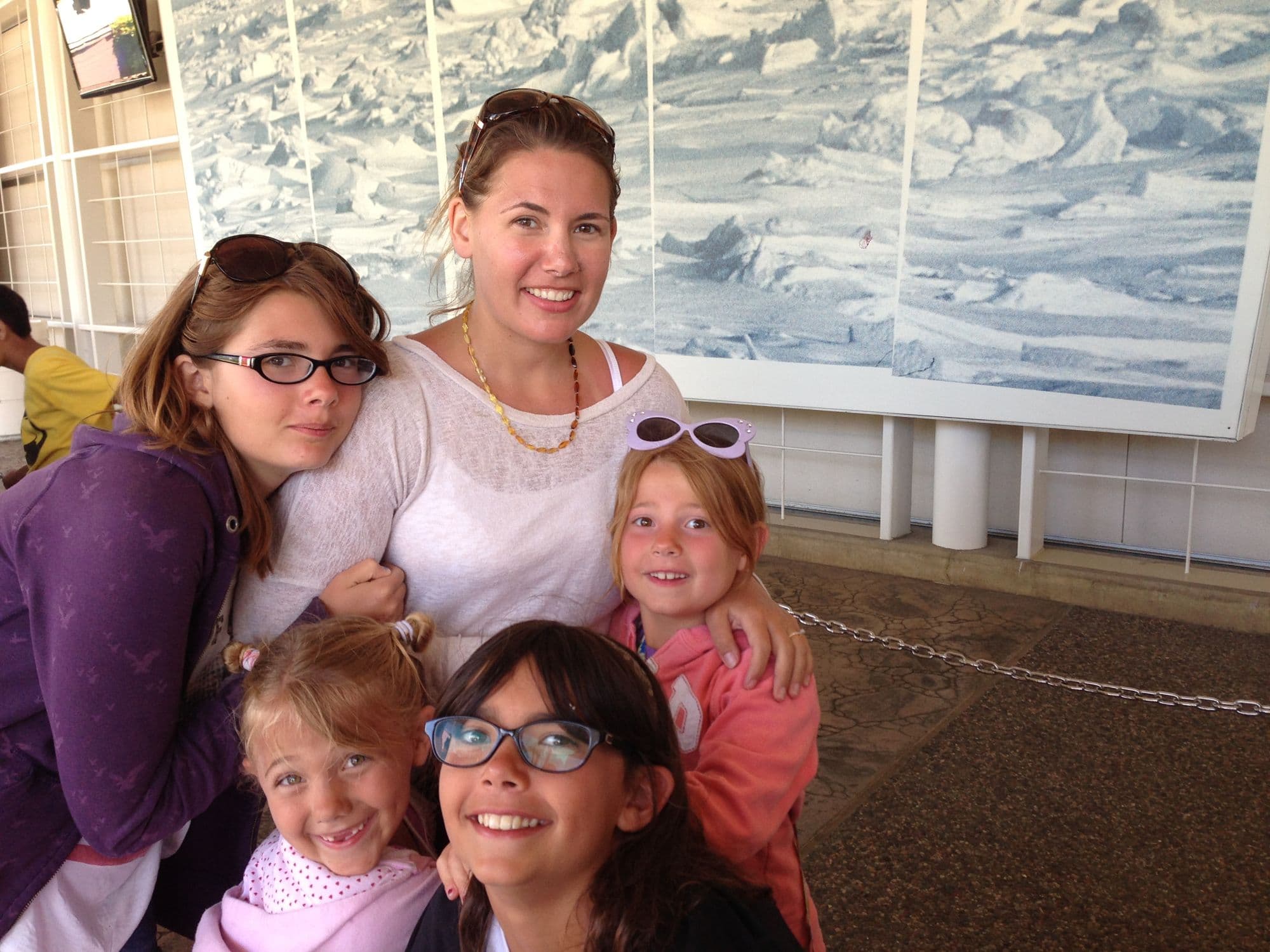 Five people in front of a large mural