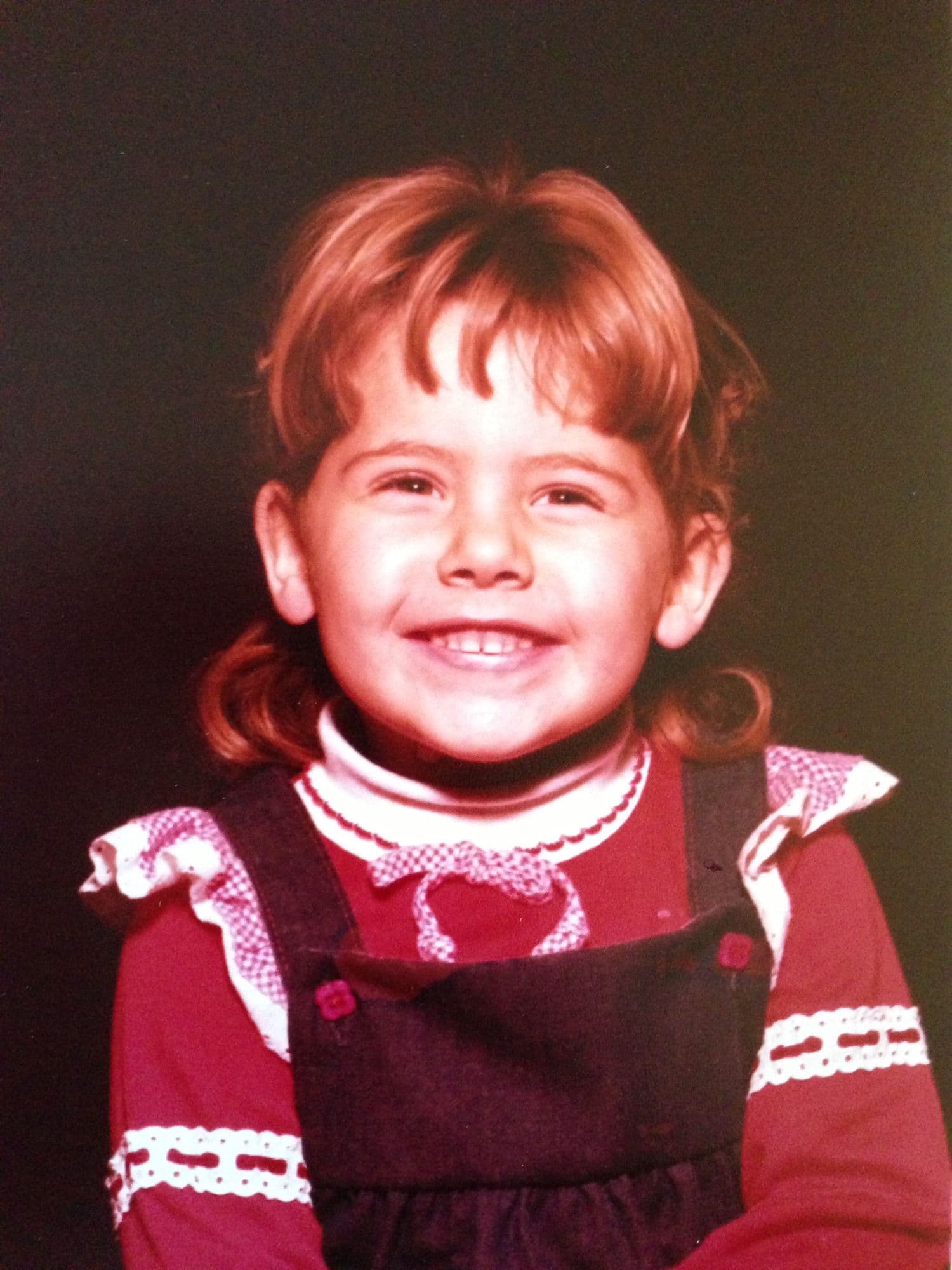 Childhood photo of a girl in a red dress