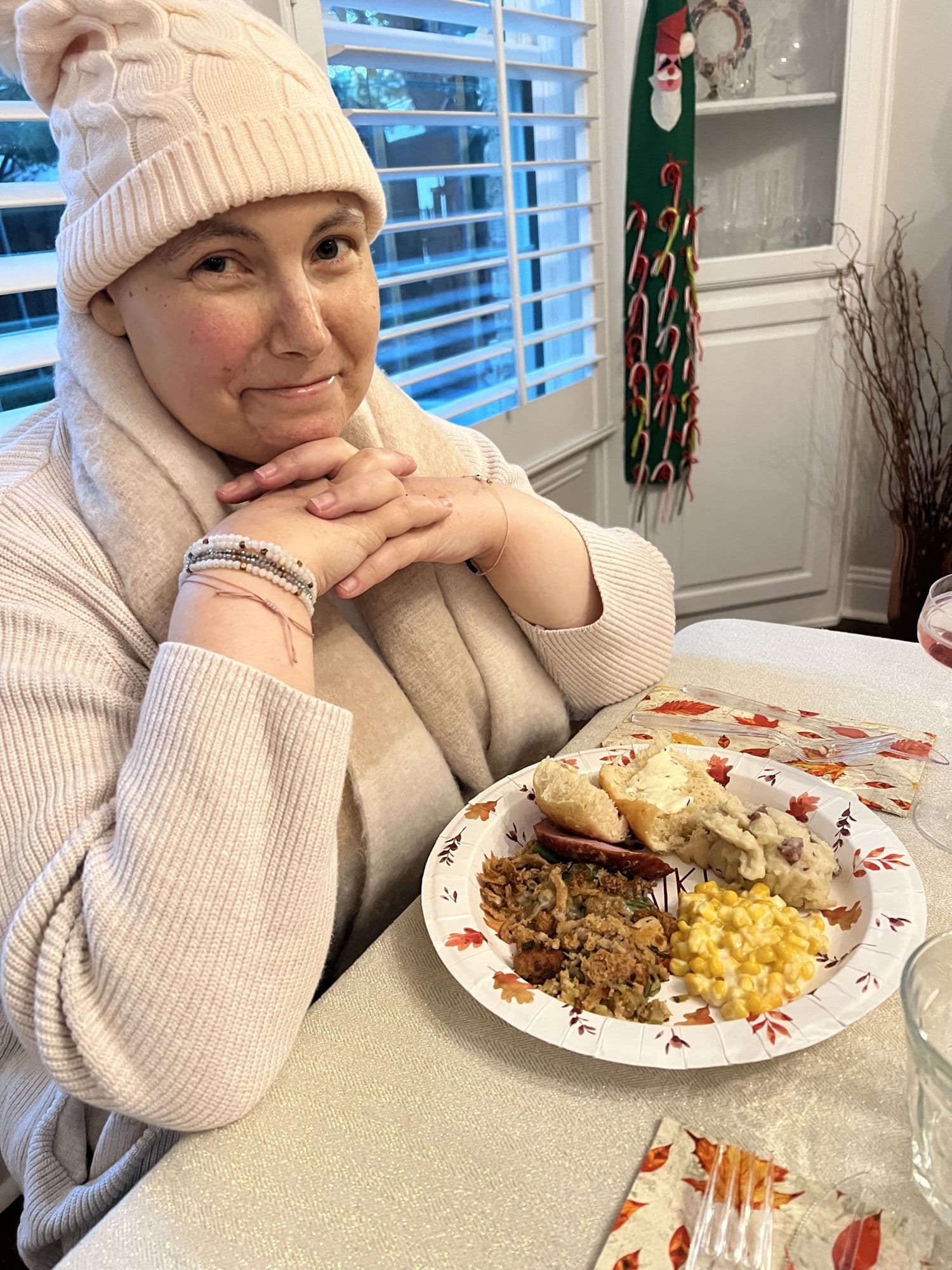 Woman resting with a Thanksgiving plate nearby