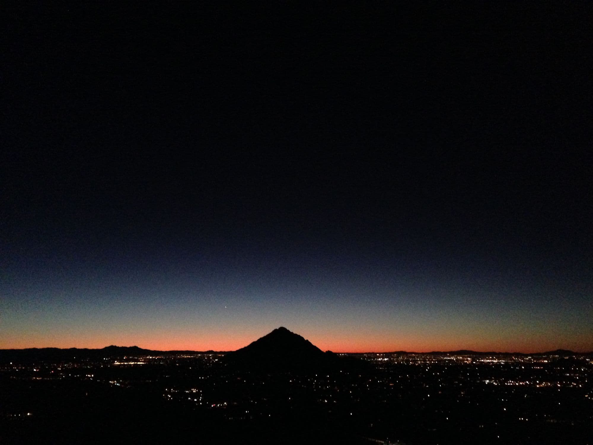 City lights at dusk from a hillside
