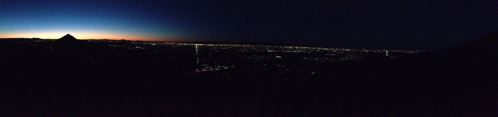 Wide panorama of city lights at dusk