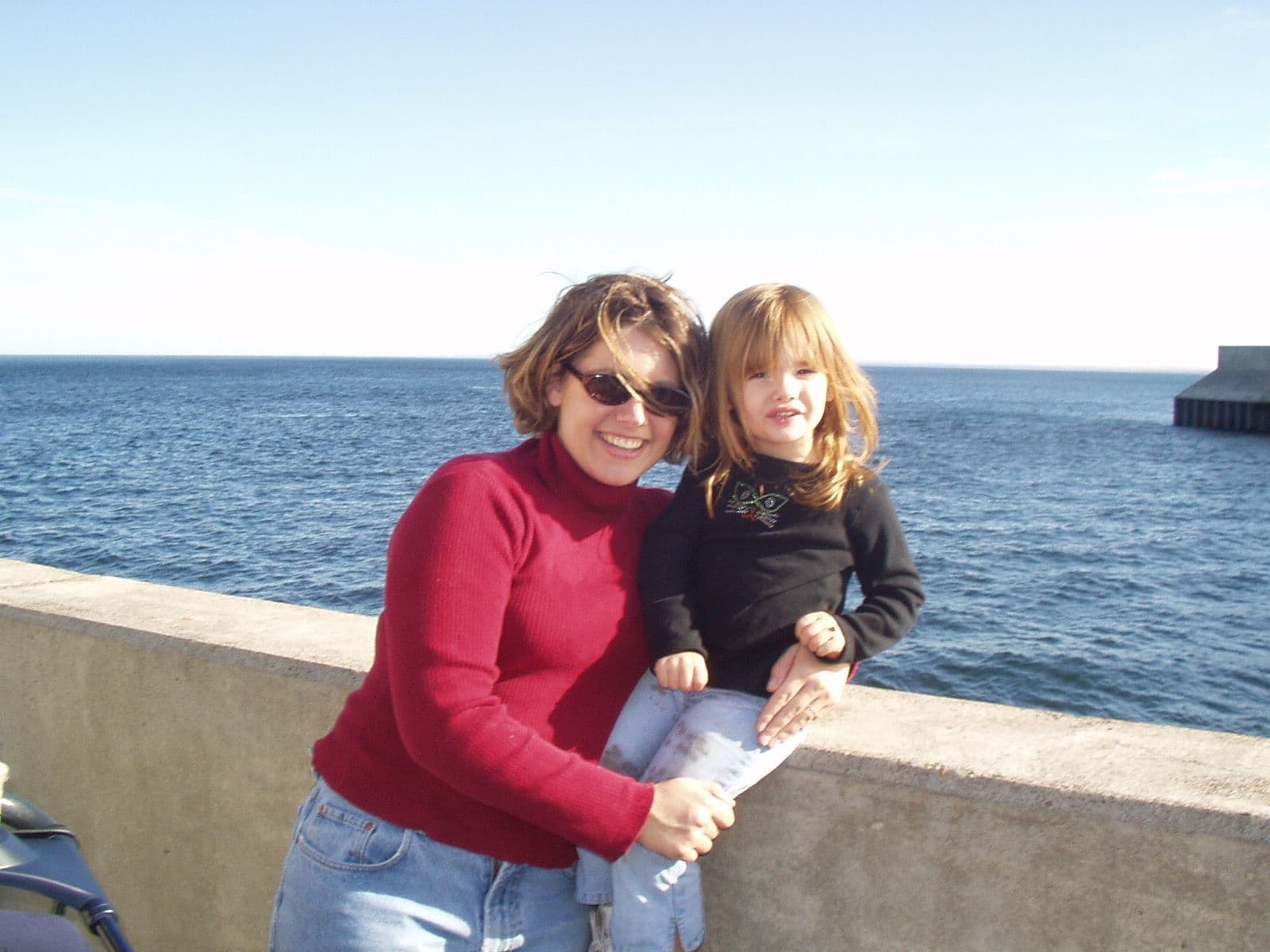 Woman and young girl on an ocean pier