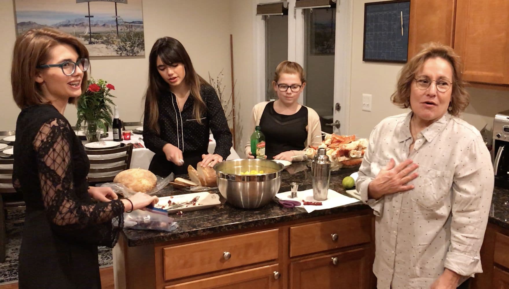 Four women preparing a holiday meal together in a kitchen