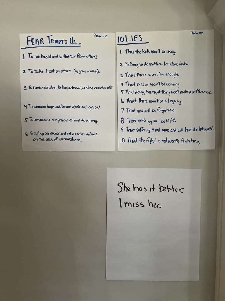 Handwritten sheets taped to a wall, headed “Fear tempts us” and “10 lies”, with a smaller note beside them